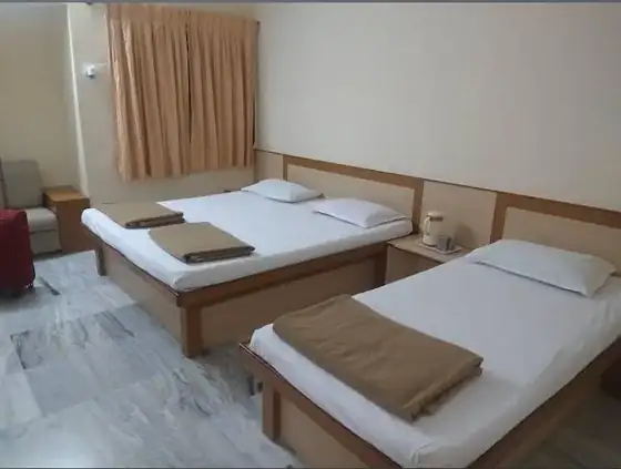 Twin bed room with fresh linen at Trilok Darshan Dharamshala, Palitana