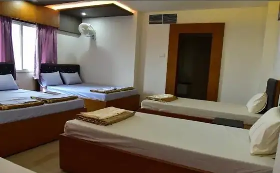Multi-bed guest room with fresh towels